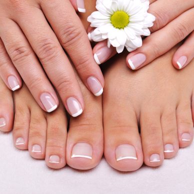 Skincare of a beauty female feet with camomile's flower