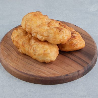 Baked piroshki with potatoes on wooden board. High quality photo