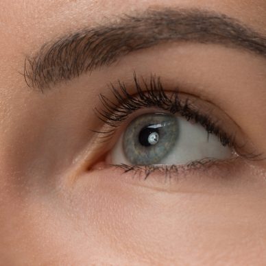 The close up gray eyes on face of young beautiful caucasian girl