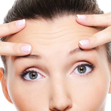 Female face with wrinkles on forehead - skincare treatment