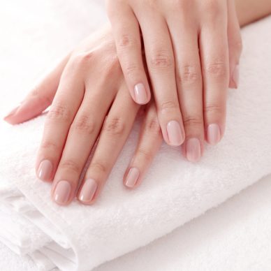 Skincare. Soft and clean hands on a white towel