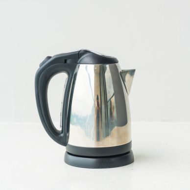 kettle and cup  on wall background with copy space