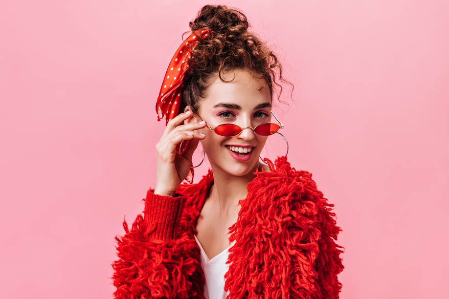 Portrait of pretty lady in red warm jacket and stylish eyeglasses