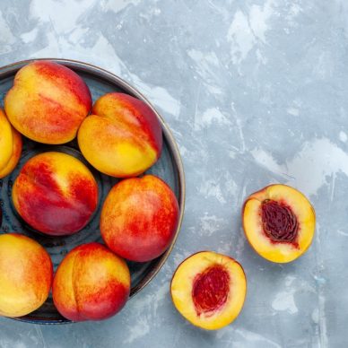 top view fresh ripe peaches delicious summer fruits on light-white desk fresh fruits mellow vitamine ripe tree