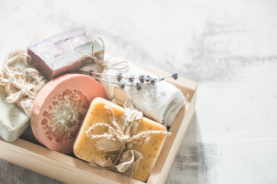 Natural soap Spa set in wooden box place for text on white background, concept of body care and healing