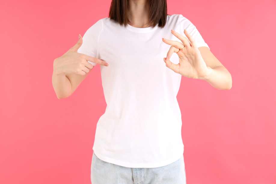 Attractive girl in white t-shirt on pink background