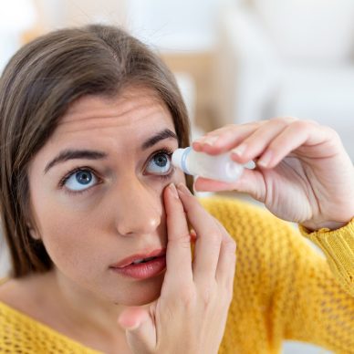 Woman using eye drop, woman dropping eye lubricant to treat dry eye or allergy