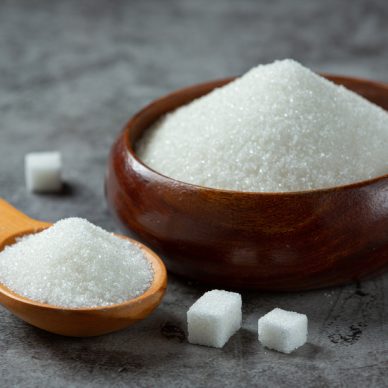 World diabetes day; sugar in wooden bowl on dark background
