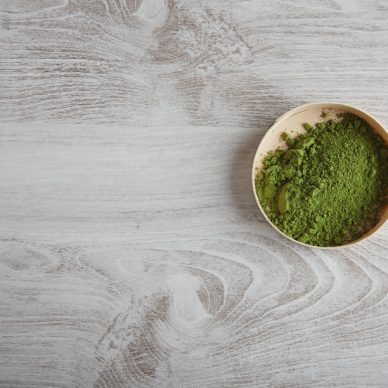 Top view organic premium matcha tea powder in wooden box isolated on white simple table alone