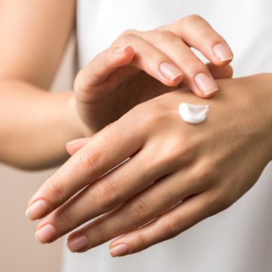 skincare. close up view of woman hand moisturising them with cream. skincare.