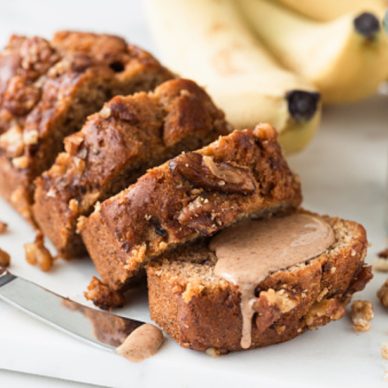 Vegan gluten free Banana bread with walnuts cut into slices, closeup view