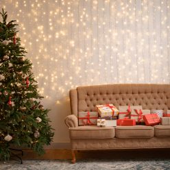 Christmas living room with a christmas tree and presents on the sofa