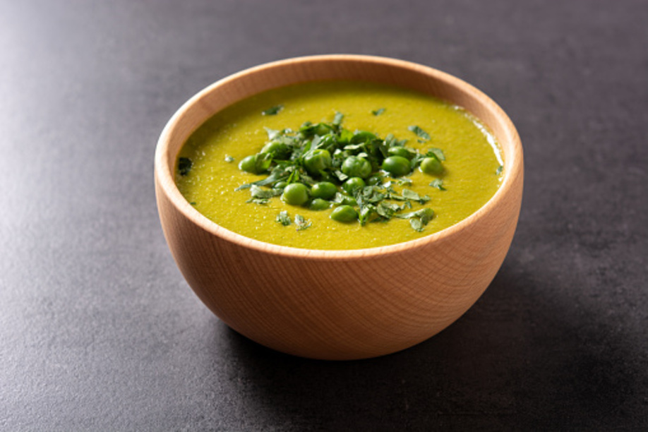 Green pea soup on black slate background