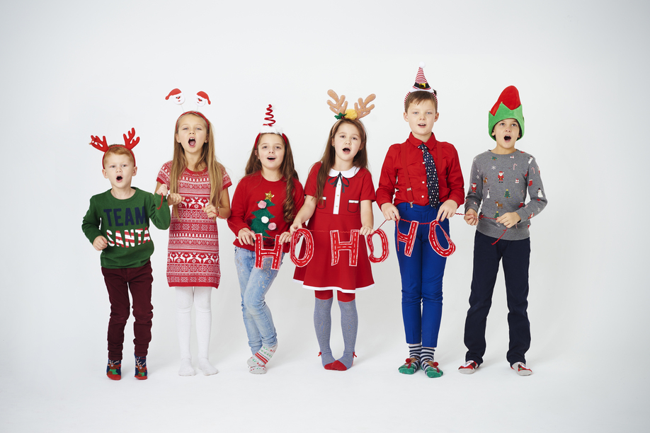 Happy children singing christmassy carols
