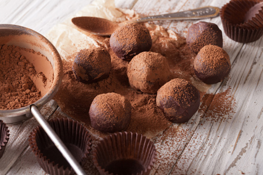 chocolate truffles sprinkled with cocoa powder close-up on the table. horizontal