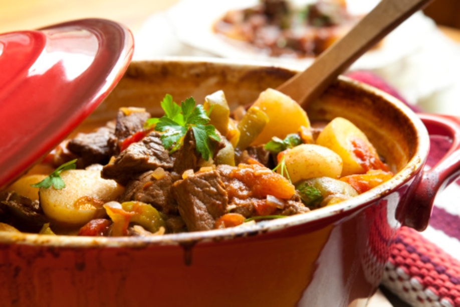 Traditional goulash or beef stew, in red crock pot, ready to serve.  Shallow DOF.  More beef images: