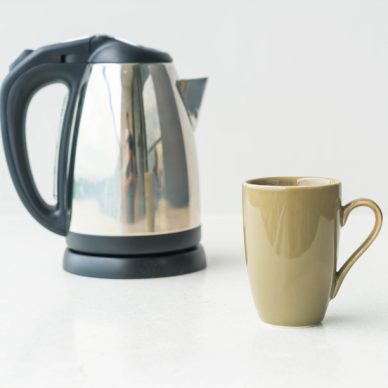 kettle and cup  on wall background with copy space