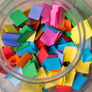 multicolored lottery tickets in jar closeup