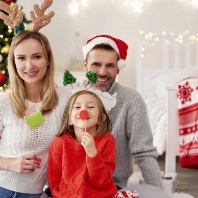 Portrait of smiling family in Christmas masks
