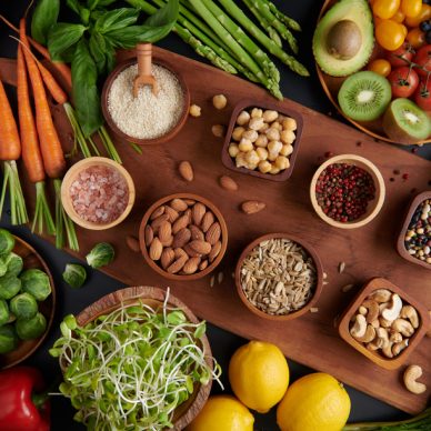 Different vegetables, seeds and fruits on table. Healthy diet.
vegetarian, vegan food cooking ingredients. Flat-lay of vegetables, fruit, beans, cereals, kitchen utencil, dried flowers, top view.