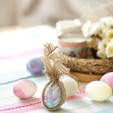 Easter composition with festive eggs on blurred background close up.