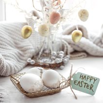Easter still life with Easter eggs and details of the festive decor. Festive Easter composition with eggs and the inscription Happy Easter.