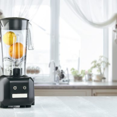 The electric blender for make fruit juice or smoothie on the kitchen table. The concept of a healthy diet
