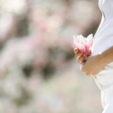 belly of a pregnant woman and a flower