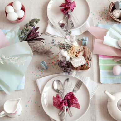 Decorated festive table with Easter dessert, tea and eggs flat lay. Happy Easter concept.