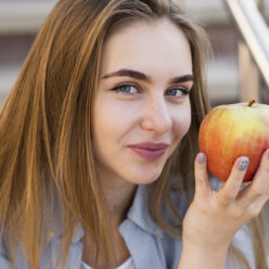 high-angle-beautiful-female-holding-apple (1)