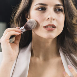 beautiful-woman-applying-makeup-by-brush (1)