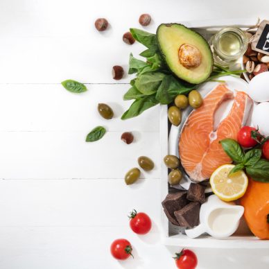 Ketogenic low carbs diet - food selection on white background. Balanced healthy organic ingredients of high content of fats for the heart and blood vessels. Meat, fish and vegetables. Copyspace.