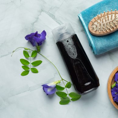 shampoo bottle of Butterfly Pea Flower put on white marble background