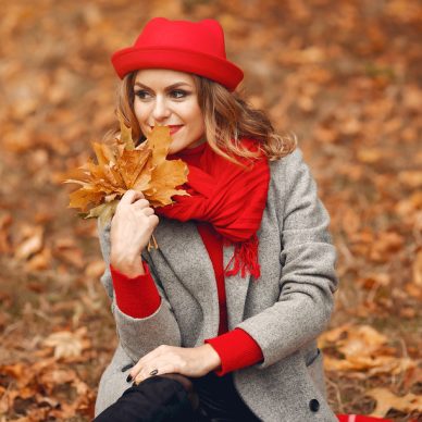 Beautiful woman in a park. Stylish girl in a red hat