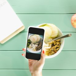 healthy-food-concept-with-hand-holding-smartphone-clipboard (1)