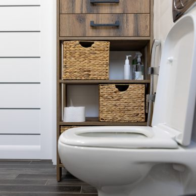 White bathroom with a toilet and straw details.
