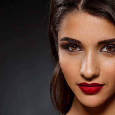 Portrait of beautiful girl over black background