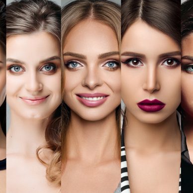 Waist up portrait of lovely pretty girl in lingerie with amazing long curly hair and perfect blue eyes. She is smiling and looking at camera with happiness. Isolated on gray background