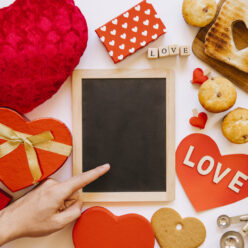 hand-near-blackboard-amidst-pastry-gifts (1)