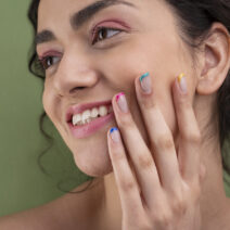 close-up-smiley-woman-with-french-manicure (1)