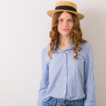 portrait of young pretty woman in straw hat jeans blue cotton shirt posing on white wall, natural look, innocent face, summer fashion trend accessories, curly blond hair young beautiful stylish woman in summer style outfit posing on white wall wearing straw hat, jeans and cotton shirt, natural look, hipster casual apparel, smiling model, fashion trend, isolated
