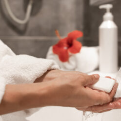 Close up of a girl washes her hands with soap in the bathroom.